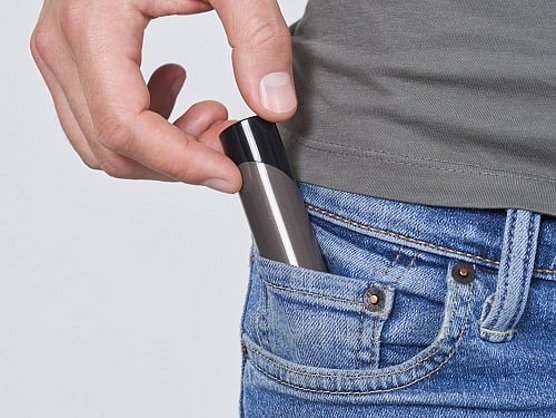 Man puts the herpotherm heating pen in his pocket.